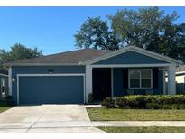 Charming single-Gathering home with a well-maintained lawn and a two-car garage at 4497 Bluff Oak Loop, Kissimmee, FL 34746