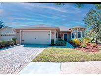 Charming single-story home featuring a paved driveway, two-car garage, and well-manicured landscaping at 531 Barcelona Dr, Poinciana, FL 34759