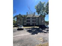 Well-maintained condo building featuring multiple stories, balconies, and convenient parking at 6148 Westgate Dr # 302, Orlando, FL 32835