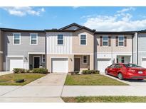 Charming townhomes with individual garages and a manicured lawn at 916 Grandin St, Davenport, FL 33837