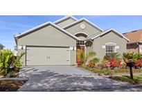 Charming single-story home featuring a lush, landscaped front yard and a two-car garage at 2102 Congress Ln, St Cloud, FL 34769