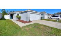 Charming single-story home with a well-maintained lawn, a two-car garage, and a cozy front entrance at 4677 Glencrest Loop, St Cloud, FL 34772