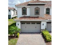 Two-story home featuring an attached two-car garage and a red-tiled roof at 14049 Millington St, Orlando, FL 32832