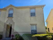 Two-story townhouse exterior featuring a decorative facade and well-maintained landscaping at 2706 Club Cortile Cir, Kissimmee, FL 34746
