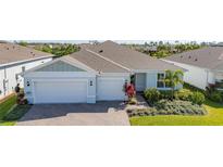 Charming single-story home featuring a brick driveway, two-car garage and meticulously landscaped front yard at 2719 River Creek Ln, St Cloud, FL 34771