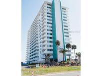 Spacious condo tower featuring multiple balconies with lovely tropical landscaping at 2800 N Atlantic Ave # 1411, Daytona Beach, FL 32118