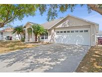 Charming single-story home with a two-car garage, mature trees, and well-maintained landscaping at 2804 Latter Day Ct, St Cloud, FL 34769