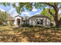 Charming single-story home with lush landscaping, mature trees and inviting curb appeal at 4911 Lazy Oaks Way, St Cloud, FL 34771