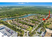 Beautiful aerial view of the community, showcasing the lake, lush landscaping, and convenient parking at 7526 Pellham Way, Kissimmee, FL 34747