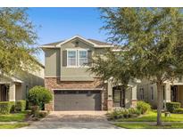 Charming two-story home with stone accents, a brick paver driveway and a two-car garage at 7615 Brookhurst Ln, Kissimmee, FL 34747