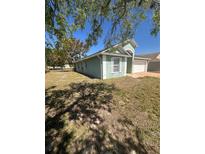 Single-story home with a two car garage and a well-maintained, grassy front lawn at 1149 E Grove Ave, Lake Wales, FL 33853