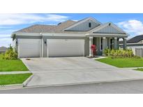 Charming single Gathering home with a well manicured lawn and 2-car garage at 14419 Topaghan Way, Winter Garden, FL 34787