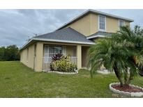 Charming home with a covered front porch, well-maintained lawn and beautiful palm tree at 2320 Andrews Valley Dr, Kissimmee, FL 34758