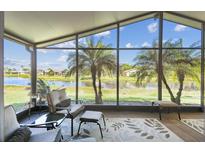 Relax in the screened lanai with views of the serene pond and swaying palm trees, perfect for enjoying the outdoors at 238 Acadia Dr, Poinciana, FL 34759