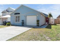 Charming single-story home with a two-car garage and a well-maintained front yard at 2432 Olive Branch Way, Orlando, FL 32817
