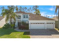 Charming two-story home with a three car garage and brick paved driveway at 376 Belfry Dr, Davenport, FL 33897