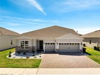 Charming single-story home boasting a three-car garage, a brick driveway and manicured landscaping at 4717 Weatherbell Rd, Winter Garden, FL 34787