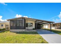 Charming single-story home featuring a covered carport and screened-in porch area at 6462 Hollyberry Ne Ln, Winter Haven, FL 33881