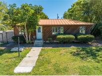 Charming single-story home with well-manicured lawn and mature trees providing curb appeal at 815 Kentucky Ave, St Cloud, FL 34769