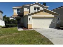 Charming two-story home with two-car garage and well-manicured lawn at 133 Rona Ln, Davenport, FL 33897