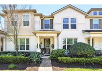 Charming two-story townhome with a well-manicured front yard and inviting entrance at 2920 Windmill Dr, Kissimmee, FL 34741