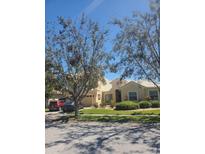 Well maintained home with a stucco facade, mature trees, and a manicured lawn at 4032 Bougainvillea Pl, Kissimmee, FL 34746