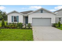 Charming single-Gathering home with a manicured lawn and a two-car garage at 1039 Wisteria Way, Dundee, FL 33838