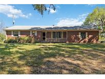 Charming single-story brick home with a cozy porch and mature trees, offering a peaceful setting at 3970 Kissimmee Park Rd, St Cloud, FL 34772