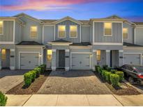 Charming townhome with brick driveway, one car garage, and manicured landscaping at 4672 Tribute Trl, Kissimmee, FL 34746
