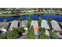 An aerial view of a row of homes along a tranquil canal, showcasing neighborhood scenery and surrounding landscaping at 585 Grand Canal Dr, Poinciana, FL 34759
