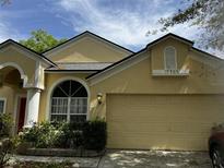 Charming single-Gathering home with a two-car garage and well-manicured landscaping at 10809 Oak Glen Cir, Orlando, FL 32817