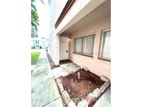 Condo exterior featuring a well-maintained front yard and a welcoming entrance at 2538 Citrus Club Ln # 105, Orlando, FL 32839