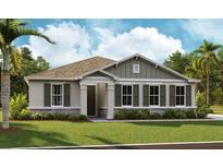Charming one-story home with a well-manicured lawn, stone accents, a covered entryway, and tasteful landscaping at 2955 Gavin Sky Dr, Kissimmee, FL 34744