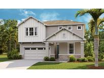 Charming two-story home with a two-car garage, complemented by lush landscaping and a welcoming front porch at 2967 Gavin Sky Dr, Kissimmee, FL 34744