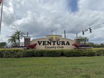 The Ventura Country Club entrance sign is framed by lush landscaping and palm trees, welcoming residents and guests at 3592 Southpointe Dr # 2, Orlando, FL 32822