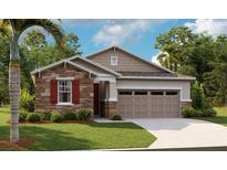 Charming single-Gathering home with stone accents, attached two-car garage, and well-manicured front lawn at 4075 Bannock Ave, Tavares, FL 32778