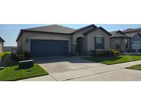 Charming single story home with a two-car garage, brick-paved driveway and landscaped front yard at 426 Citrus Isle Loop, Davenport, FL 33837