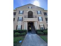 Attractive three-story condo building with well-manicured landscaping and elegant architectural details at 14341 Fredricksburg Dr # 1016, Orlando, FL 32837