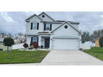 Charming two-story home with landscaped front yard and two-car garage at 2015 Barstow Ln, Dundee, FL 33838