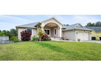 Charming single-story home featuring lush landscaping and a welcoming covered front porch at 5524 Loma Vista, Davenport, FL 33896