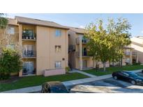 Charming condo building with neutral tones, balconies, well-maintained landscaping, and ample parking at 5226 Via Hacienda Cir # A314, Orlando, FL 32839