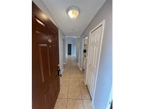 Inviting entryway features neutral walls, ceramic tile floor, and a view through to the rest of the property at 5226 Via Hacienda Cir # A314, Orlando, FL 32839