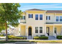 Charming two-story townhouse featuring a well-maintained front yard and inviting facade at 1370 Kiawah St, Celebration, FL 34747