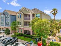 Multi-story condominium featuring private screened balconies and a well-maintained lawn at 3344 Corona Village Way # 308, Orlando, FL 32835