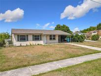 Charming single-story home with neutral siding, complemented by a green lawn and a welcoming covered entry at 4343 Lake Richmond Dr, Orlando, FL 32811