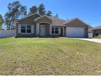Charming single-story home with well-manicured lawn, attached garage, and inviting front entrance at 4490 Sw 169Th Pl, Ocala, FL 34473