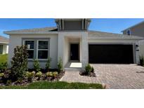 Charming single-story home with a dark garage door, neutral paint, and a well-manicured lawn at 4812 Worchester Dr, Kissimmee, FL 34746