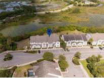 Scenic aerial view of townhomes and surrounding natural Florida landscape with ponds and lush greenery at 510 Captiva Dr, Davenport, FL 33896