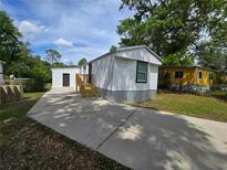 Charming exterior of a one-story home with a large driveway and front yard at 5161 Howison Rd, Kissimmee, FL 34746