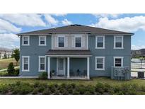 Inviting home exterior showcasing a cozy front porch and tidy landscaping at 11713 Tidal Alley Trl, Orlando, FL 32832